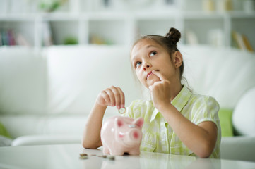 beautiful girl with a piggy bank