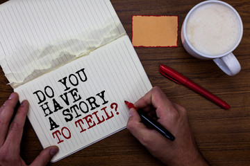 Handwriting text writing Do You Have A Story To Tell question. Concept meaning Storytelling Memories Tales Experiences Sticky note red pen coffee with coffee mug hand hold pen with written words.