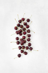 Red Cherries on White Textured and Patterned Background