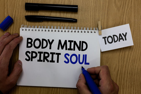 Word writing text Body Mind Spirit Soul. Business concept for Personal Balance Therapy Conciousness state of mind Hand hold pen notepad with words paperclip grip note paper woody base black pen.
