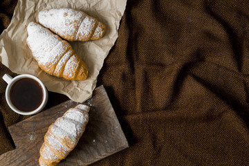 Croissants and a cup of hot drink for breakfast. Copy space. 