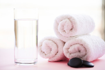 Obraz na płótnie Canvas Spa. White Cotton Towels Use In Spa Bathroom on Pink Background. Towel Concept. Photo For Hotels and Massage Parlors. Purity and Softness. Towel Textile