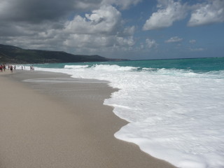 Fototapeta na wymiar onde spumose sulla spiaggia