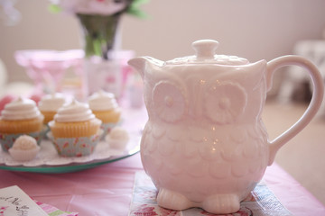 owl teapot on the table. cupcakes. sweet bar . candy 