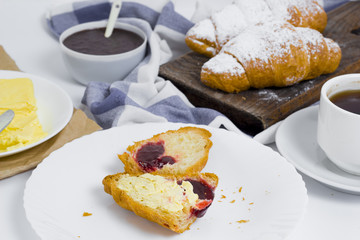 Breakfast with croissants, chocolate cream and coffee. 