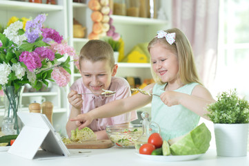 Cute little brother and sister cooking