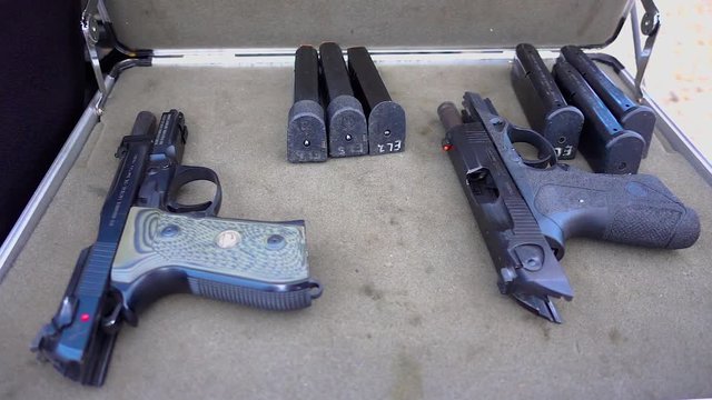 Slow motion of Beretta handguns and magazines