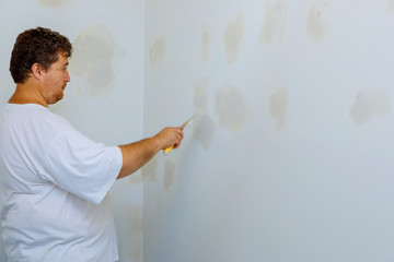 house improvements. putting plaster on the wall with spatula