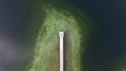 Top view aerial photo from flying drone of a beautiful sea landscape with amazing blue and green water with Turkey sea with pier.