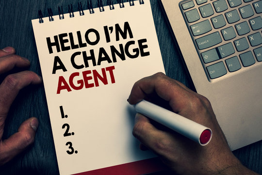Text sign showing Hello I am A Change Agent. Conceptual photo Promoting and enabling difference evolution new Written words and number on notepad man hold marker keyboard on wooden desk.