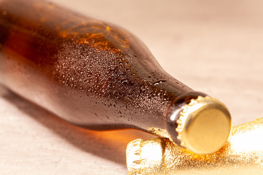 a bottle of beer amber lying with its capsule