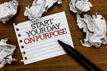 Text sign showing Start Your Day On Purpose. Conceptual photo Have clean ideas of what you are going to do Paper lumps laid randomly around white notepad touch black pen on woody floor.