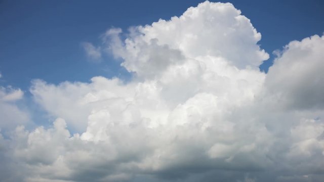 Cumulonimbus cloud on blue sky background, time-lapse