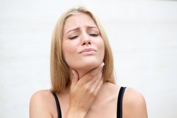 Pretty blond woman with sore throat
