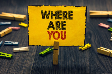 Word writing text Where Are You. Business concept for Give us your location address direction point of reference Blacky wooden desk laid paper clip randomly one hold yellow board with text.