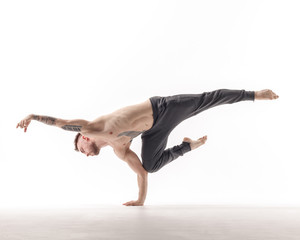 Young beautiful dancer is posing in studio