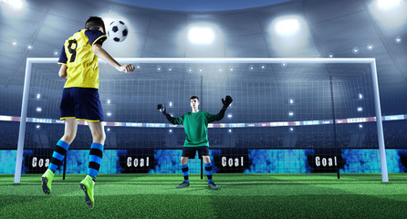 Young soccer player is kicking ball while goalkeeper defends on a professional soccer stadium. Stadium and crowd are made in 3D. Players in unbranded cloth.