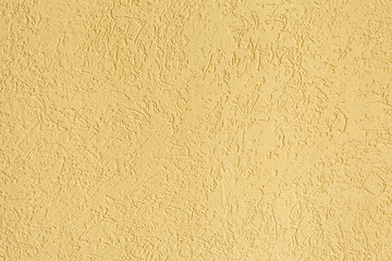 texture of the surface of the wall covered with decorative plaster of the woodworm type