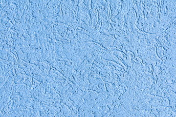 texture of the surface of the wall covered with decorative plaster of the woodworm type