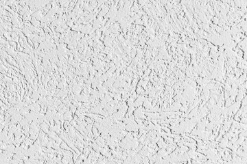 texture of the surface of the wall covered with decorative plaster of the woodworm type