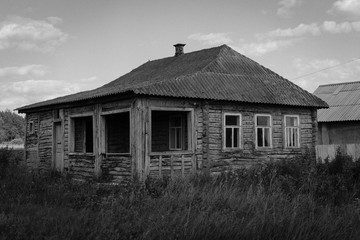 Old abandoned wooden house. Black and white photo.