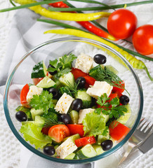 Salad of fresh vegetables and cheese on  served table