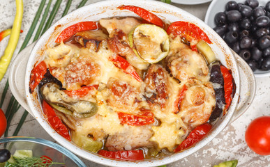 Traditional tasty rustic stew of chicken and vegetables  with Greek salad and black olives