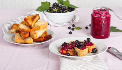 Delicious toasts bread with homemade currant jam with fork and knife