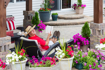 Smiling happy man relaxing on his outdoor patio