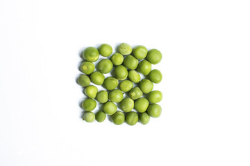 Green peas on a white background. Peas lined in the form of a square.