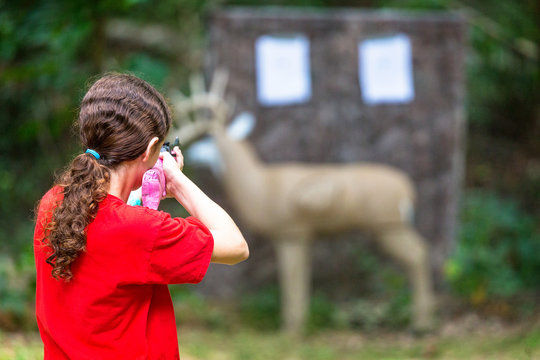 Girl Shooting BB Gun at Deer Target