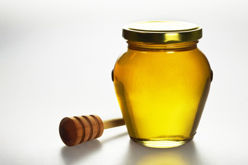 Honey jar on light background
