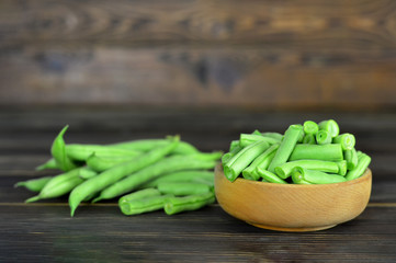 Fresh green beans on wooden background