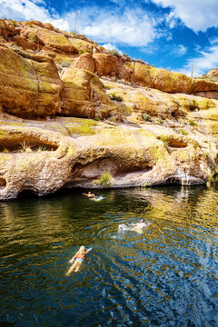 People Swimming in Arizona Lake Towards Canyon Walls