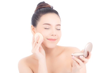 Obraz na płótnie Canvas Portrait of beautiful asian woman applying powder puff at cheek makeup of cosmetic, beauty of girl with face smile isolated on white background, wellness and healthcare concept.
