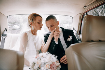 Wedding photo in the car.The bride and groom in a retro car.