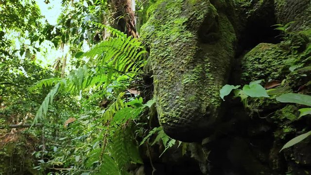 Komodo dragon statue. Ubud sacred Monkey Forest sanctuary in Bali island popular tourist attraction and travel destination. Artistic religious stone carving and traditionla Hindu decoration sculpture