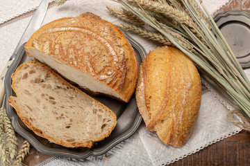 Sourdough homemade round white wheat bread with slices close up