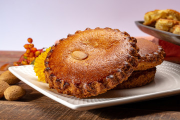 Round Dutch homemade cookies filled with marzipan and almonds nuts, autumn and winter seasonal dessert in Netherlands
