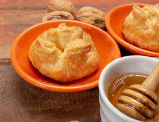 French snack pouches made from puff pastry with fresh soft goat cheese and honing