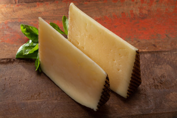 Two pieces of Manchego, queso manchego, cheese made in La Mancha region of Spain from the milk of sheep of the manchega breed