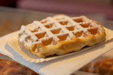Fresh baked Belgian waffle with white sugar powder