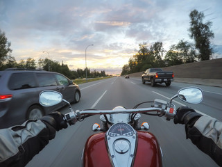 Riding a motorcycle during a vibrant sunset. Taken in Surrey, Greater Vancouver, British Columbia,...