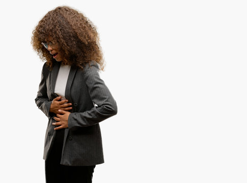 African american business woman wearing glasses with hand on stomach because nausea, painful disease feeling unwell. Ache concept.