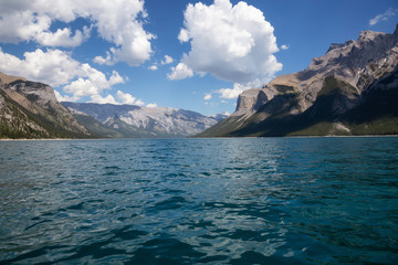 Fototapeta na wymiar Lake Minnewanka during a vibrant sunny summer day. Taken in Banff, Alberta, Canada.