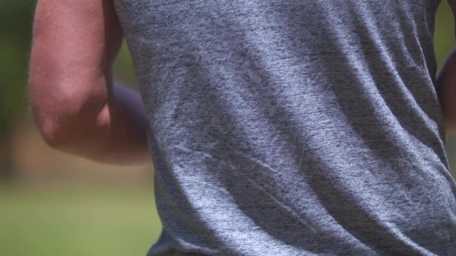Slow-motion closeup of a man teeing off while playing frisbee golf.  Shot on a Blackmagic Ursa Mini Pro 4.6k with a Sigma 50-100mm f/1.8.