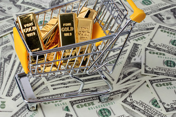 Gold bars 1 kg, in shopping  trolley with yellow mark for supermarket paced on bank note.