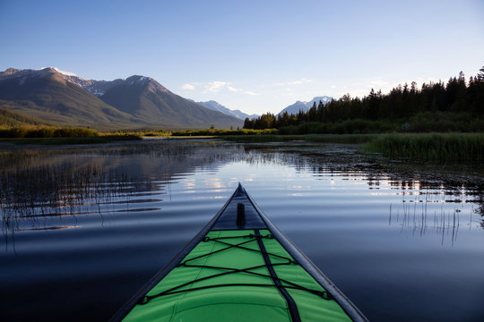 Kayaking in a beautiful lake surrounded by the Canadian Mountain Landscape. Taken in Vermilion Lakes, Banff, Alberta, Canada.