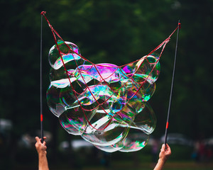 hands holding net with soap bubbles