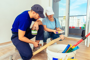 Craftsman Varnishing A Wooden Shelf Using Paintbrush. Young family renovating their home concept.